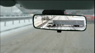 tractor trailer jack-knives on snowy freeway