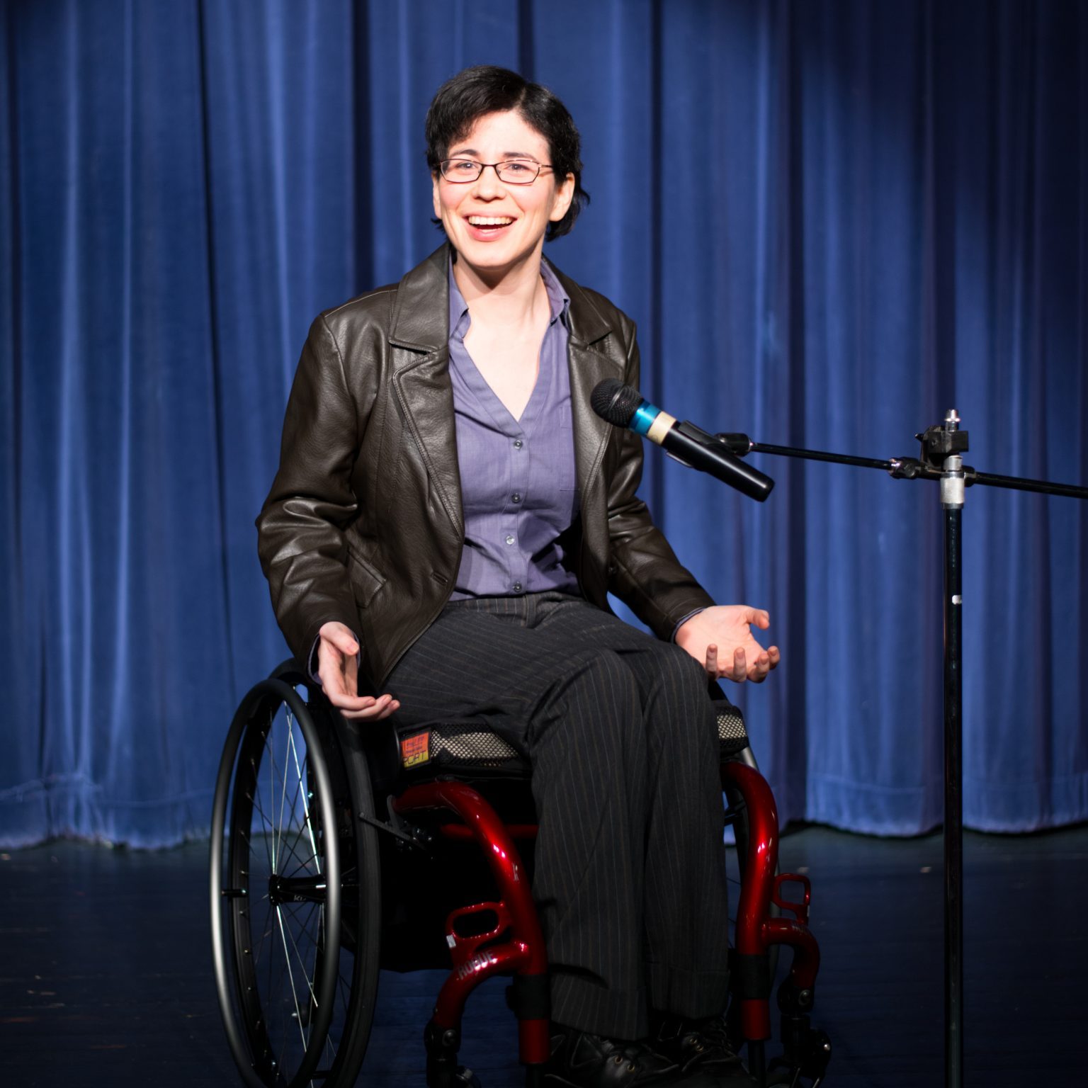 woman in a wheelchair at a microphone